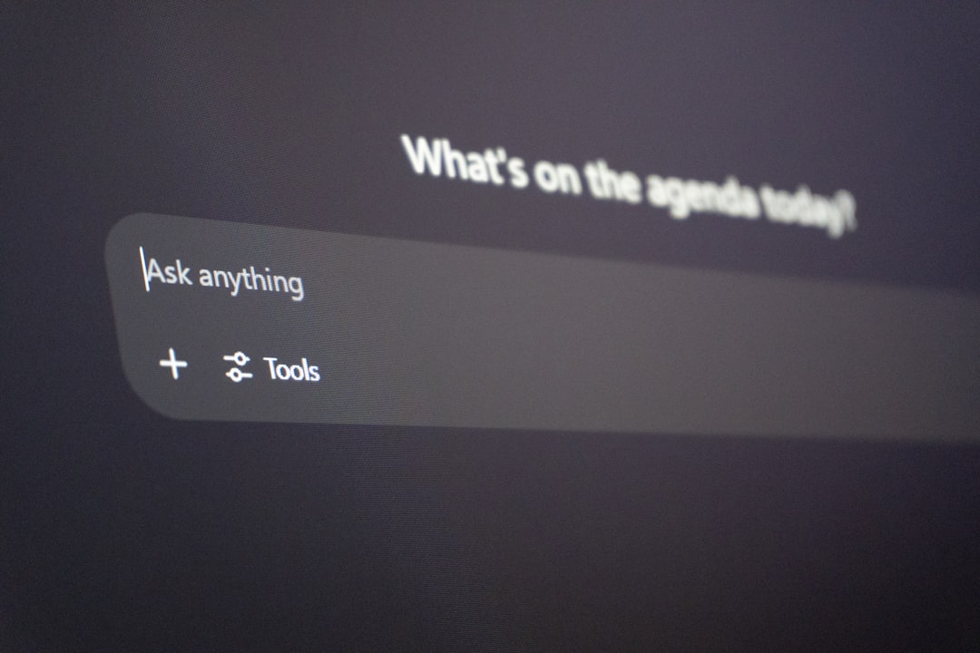 Close-up of a dark app UI with a rounded search box reading 'Ask anything' beneath a blurred header that says 'What’s on the agenda today?'