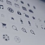 Grid of app icons on a computer screen, slightly blurred.