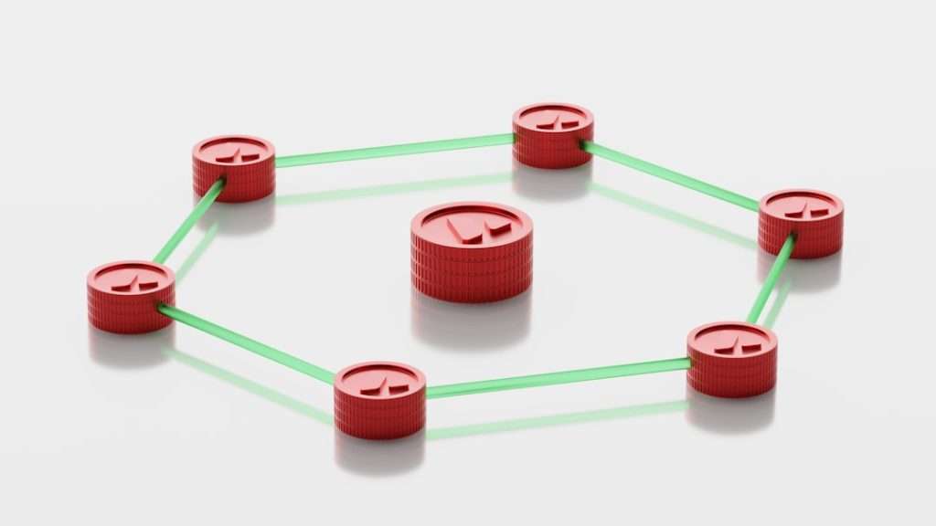 Red bottle cap nodes connected by green rods forming a hexagonal network with a central cap