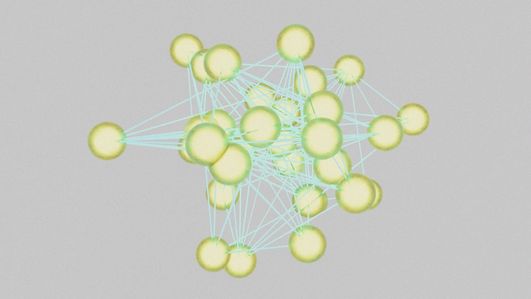 Abstract 3D network of yellow spheres connected by cyan lines, forming a dense interconnected cluster.