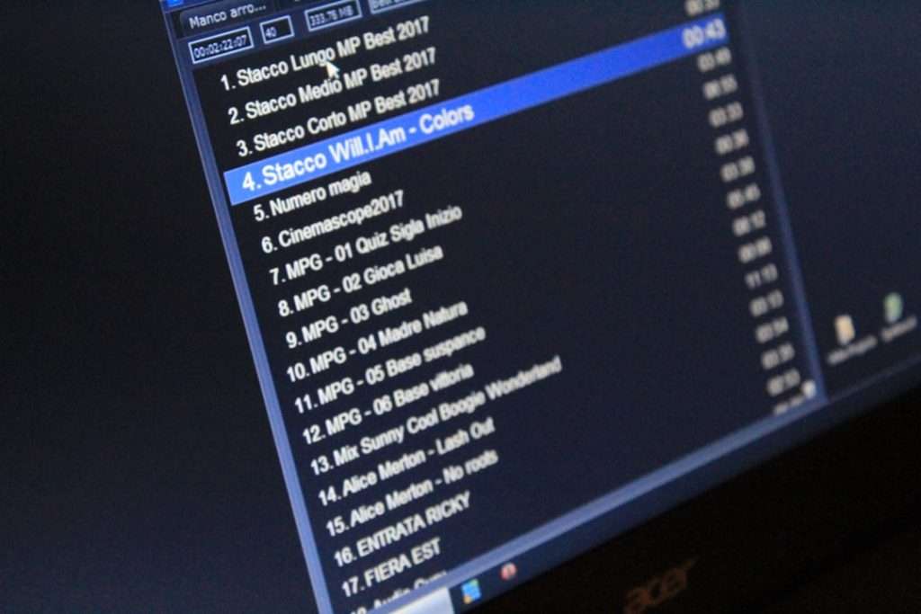 Monitor showing a playlist; track 4 'Stacco Will I Am - Colors' highlighted in blue