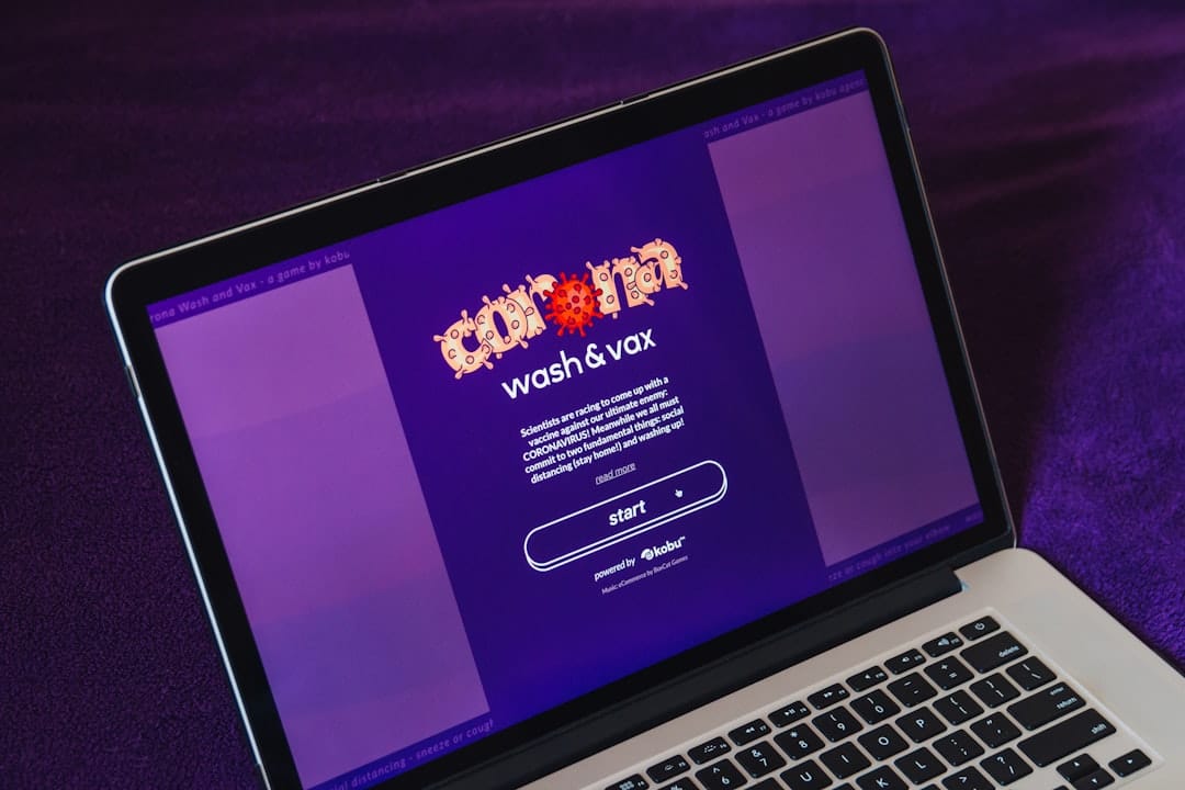 Laptop on a purple surface displaying a purple app splash screen titled 'wash & wax' with a prominent 'start' button.