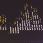 Dark terminal/console screenshot showing a vertical list of package names and versions (e.g., electron, rollup, plugin-*) in yellow and white text, rotated 90 degrees clockwise.