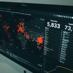 Dashboard screen showing a world map with red data points and statistics like Total Deaths 5,833 and Total Recovered 73,968 colored panels.
