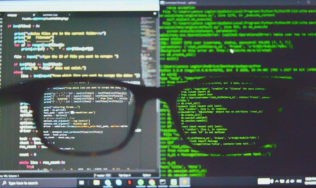 Person wearing glasses in front of dual computer screens displaying colorful code and green terminal text, suggesting programming or debugging.