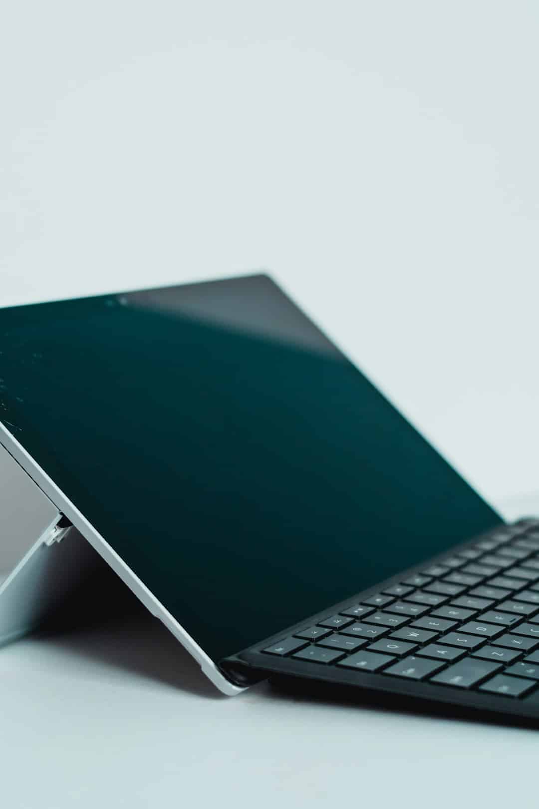 Open laptop on a light desk, keyboard in view and screen angled upward for use.