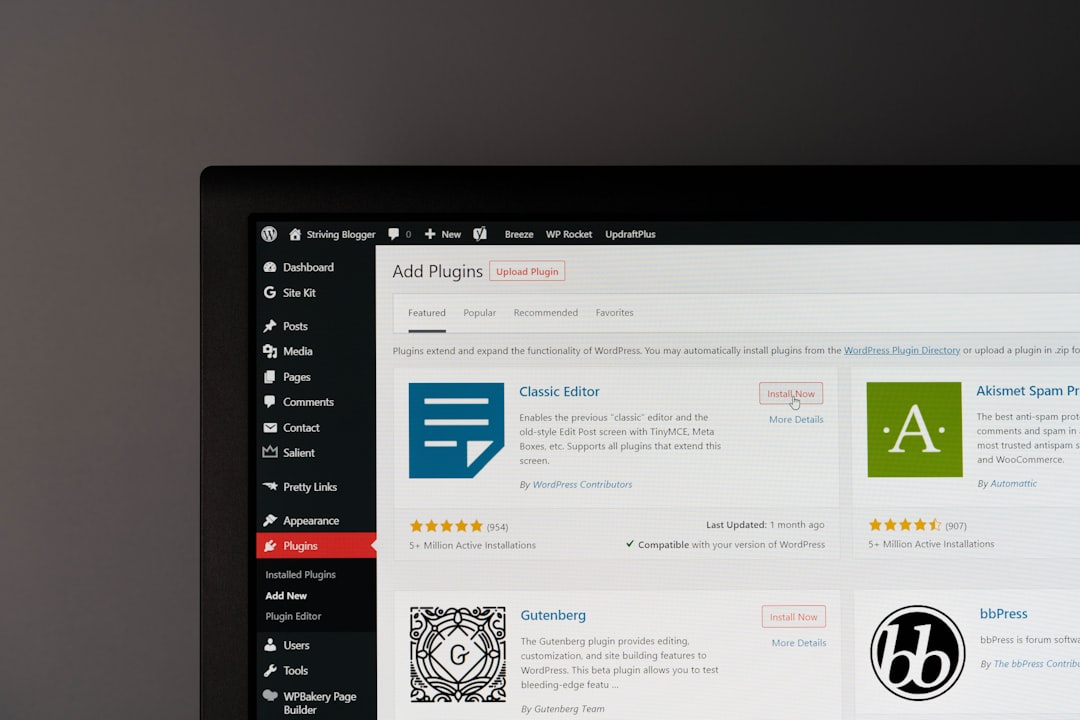 WordPress admin Plugins page on a monitor, showing plugin tiles like Classic Editor and Akismet