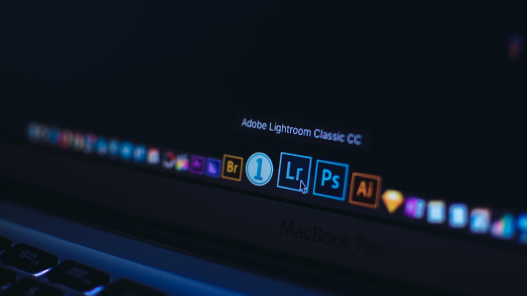 Close-up of a MacBook Pro screen showing the Lightroom Classic CC icon among other Creative Cloud app icons on the dock.