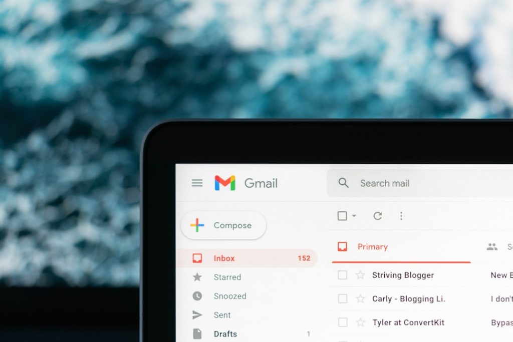 Close-up of a laptop screen displaying Gmail with the Inbox highlighted and the Compose button visible.