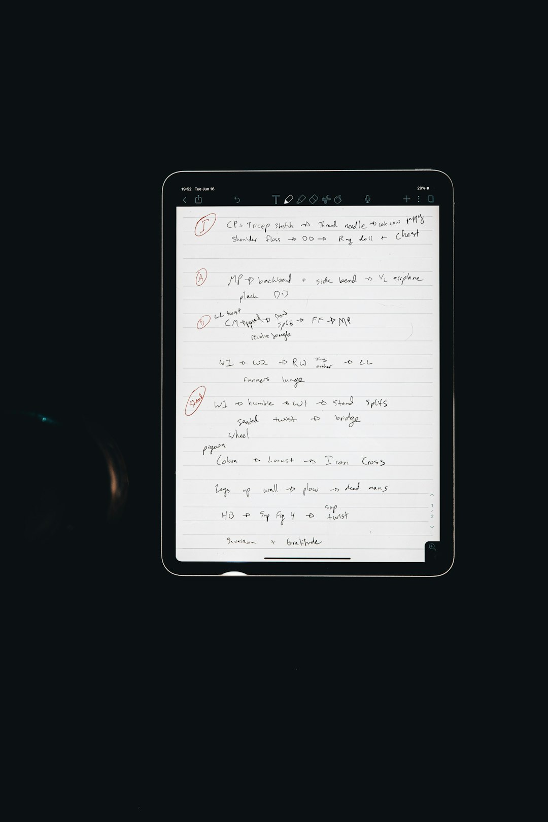 Tablet displaying a page of handwritten notes on lined paper against a dark background.