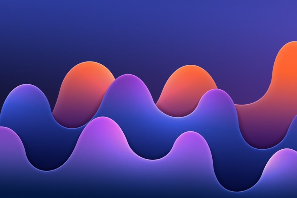 Abstract gradient waves in purple, blue, and orange forming a rolling landscape.