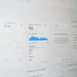 Blurry analytics dashboard with charts and a panel titled 'Users in last 30 minutes' showing 102 users and a blue bar chart on a pale screen.