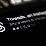 Logo for Threads app with the text 'Threads, an ...' and the subtitle 'Share ideas & thoughts with...' plus a 5-star rating showing two filled stars and three outlines.
