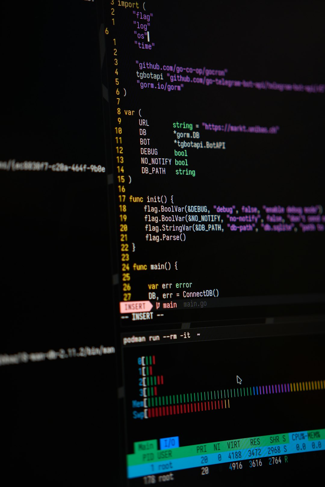 Close-up of a dark monitor displaying Go code with syntax highlighting and a terminal at the bottom.