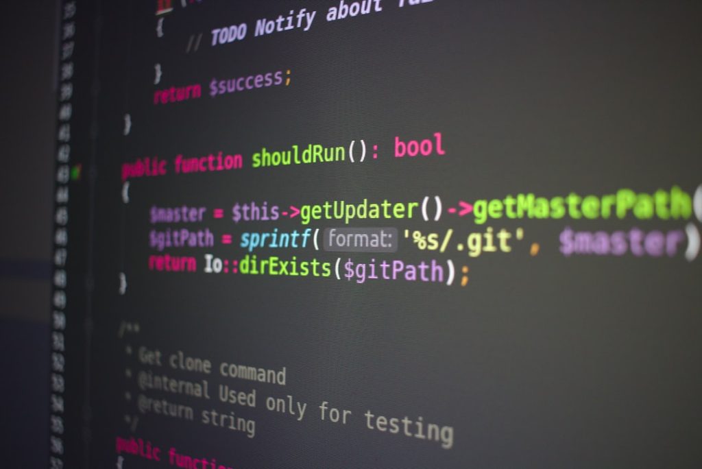 Code editor showing a shouldRun() function and path-related logic with colorful syntax highlighting on a dark screen