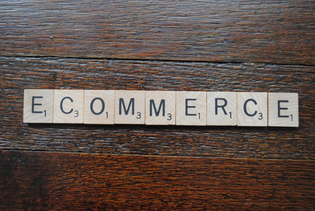 Scrabble tiles spell 'ECOMMERCE' on a dark wooden surface, representing online shopping.