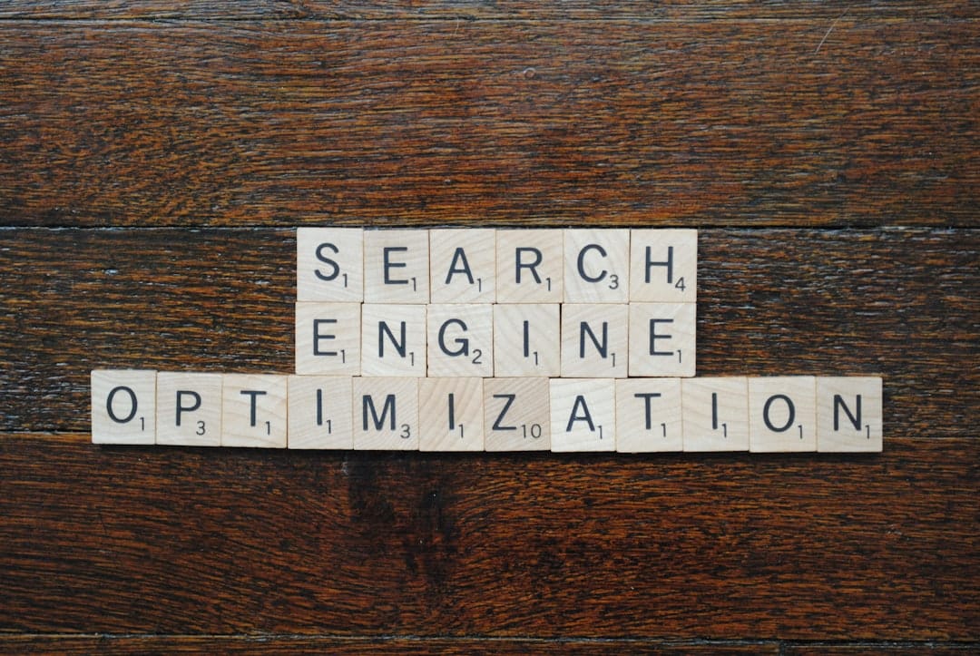 Scrabble tiles spell 'SEARCH ENGINE OPTIMIZATION' laid on a wooden table.