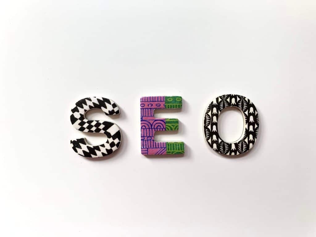 SEO text wallpaper seo planning audit checklist business strategy - AI Bud Word 'SEO' formed by decorative patterned letters on a white background (S with black/white geometric pattern, E with purple/green abstract design, O with black/white shapes).