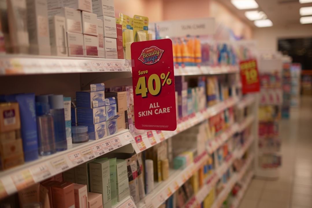 Promotional pink sign on a store shelf announces 40% off all skin care products in the cosmetics aisle