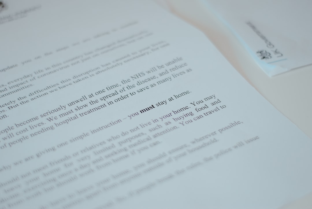 Close-up of a printed document with the bold phrase 'must stay at home'.