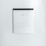 Minimalist white calendar on a wall, showing January 1, 2020 with a grid of days beneath the month.