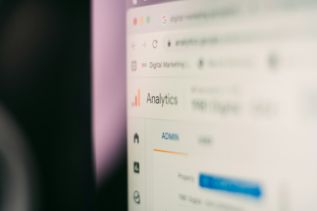 Close-up of a computer screen displaying an analytics dashboard with the word Analytics and an admin panel on the left.
