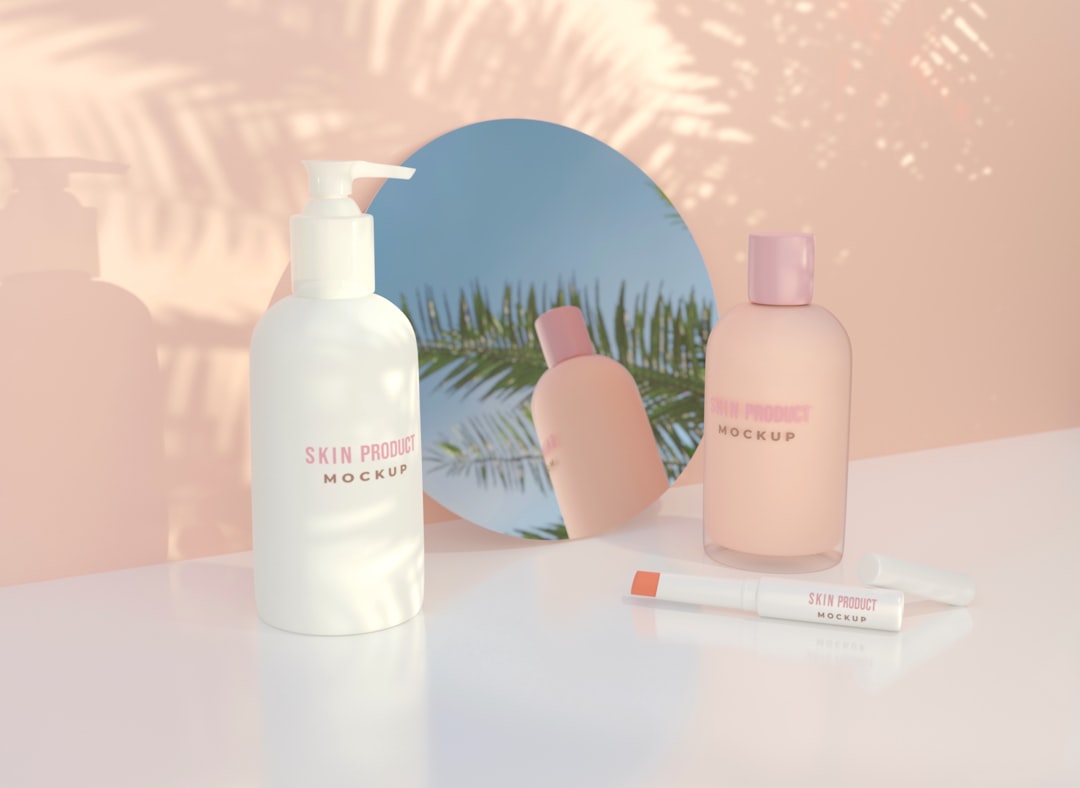 Skincare product display: white pump bottle, pink bottle, and lip product on a glossy white surface with a peach backdrop and round mirror reflecting palm leaves.