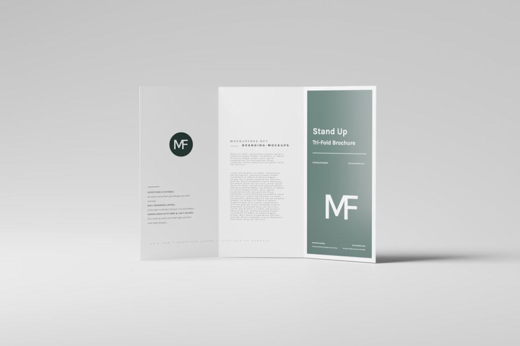 Tri-fold brochure mockup on a light gray background; left panel shows a dark circular MF logo, middle panel text, right panel a green gradient with 'Stand Up' and MF.