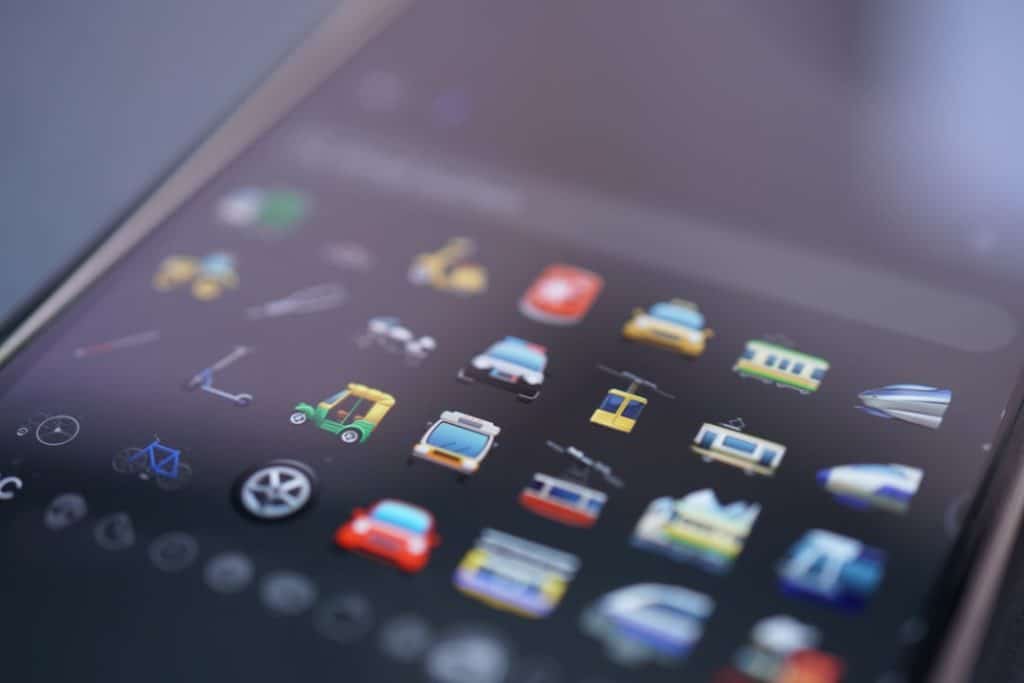 Close-up of a smartphone home screen with a grid of colorful app icons blurred in the background.