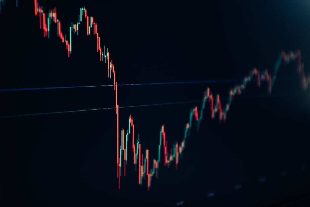 Candlestick chart showing a sharp drop followed by a gradual recovery on a dark background.