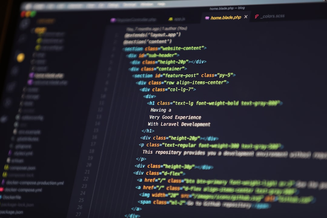 Close-up of a dark-themed code editor on a monitor with colorful HTML/CSS syntax highlighting.