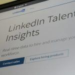 LinkedIn Talent Insights webpage on a monitor, showing the tagline 'Real-time data to hire and manage your workforce' and a 'Contact sales' button.