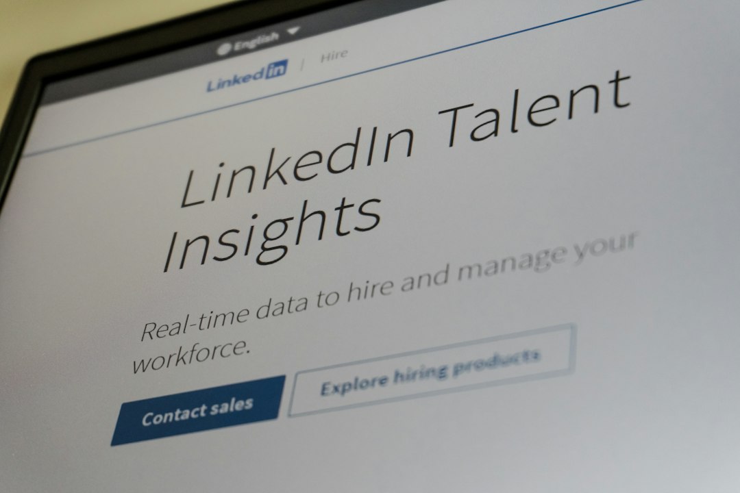 LinkedIn Talent Insights webpage on a monitor, showing the tagline 'Real-time data to hire and manage your workforce' and a 'Contact sales' button.