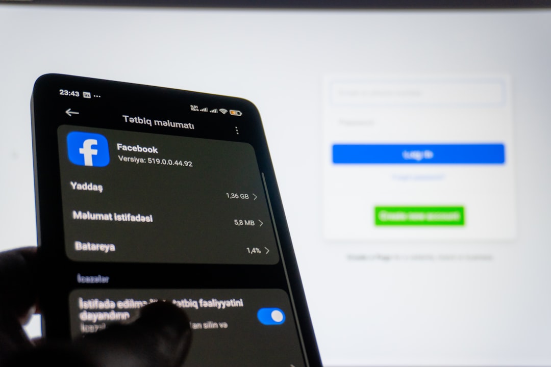 Phone screen shows Facebook app info and usage stats (in Azerbaijani); a blurred login screen is visible on a monitor in the background.
