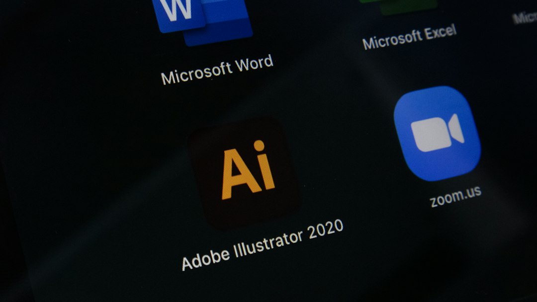Adobe Illustrator 2020 app icon shown among other software icons (Word, Excel, Zoom) on a dark screen, indicating a home/screen grid view.