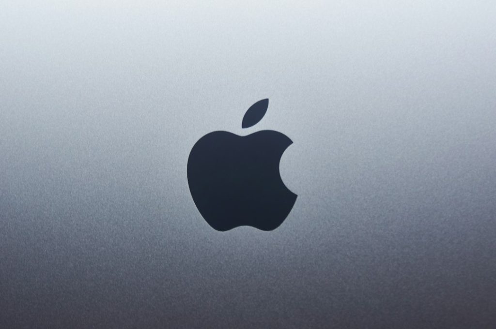 Apple logo centered on a blue‑gray gradient background