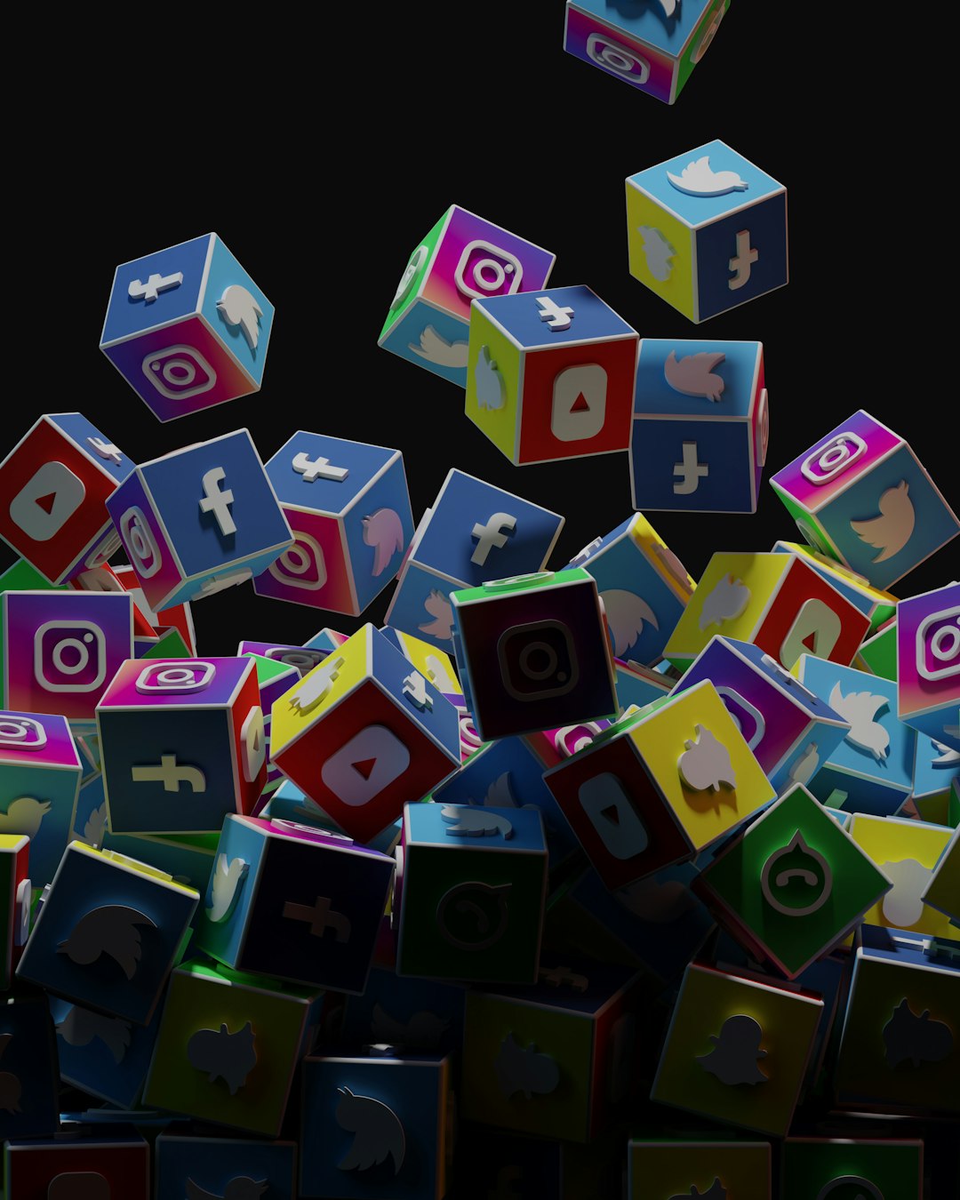 Colorful 3D social media app cubes tumbling in a dark space, showing icons like Facebook, Instagram, YouTube, Twitter, and more.