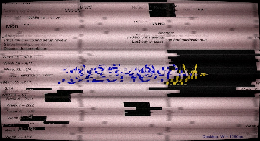 A computer monitor displaying a corrupted, glitchy screen with scattered text, black bars, and blue scribbles across the center, suggesting a display crash.