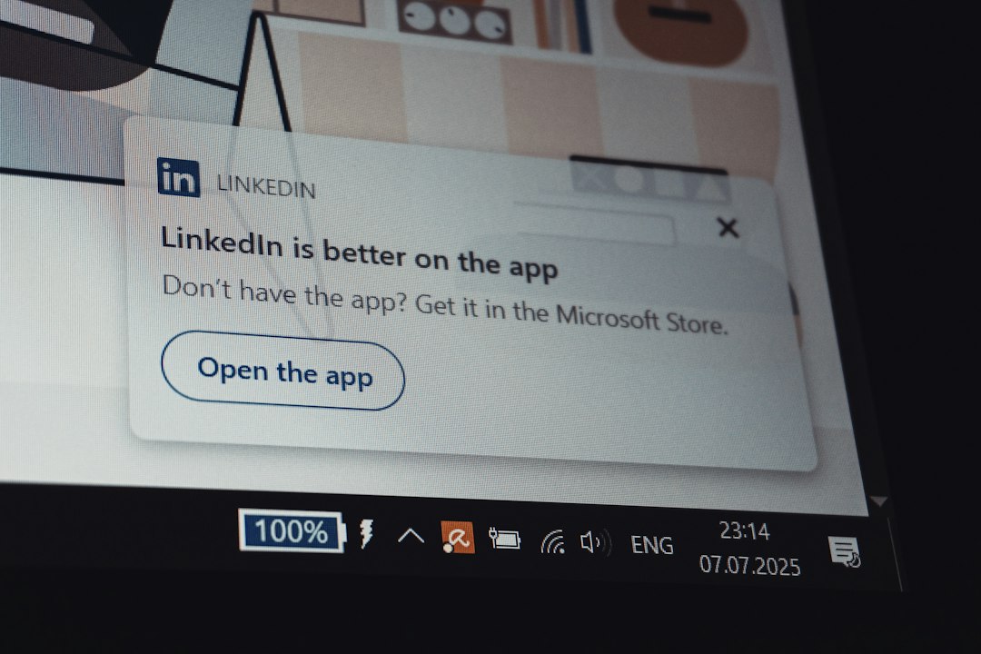 LinkedIn notification pop-up on a laptop screen inviting you to 'Open the app' with a rounded button labeled 'Open the app'.
