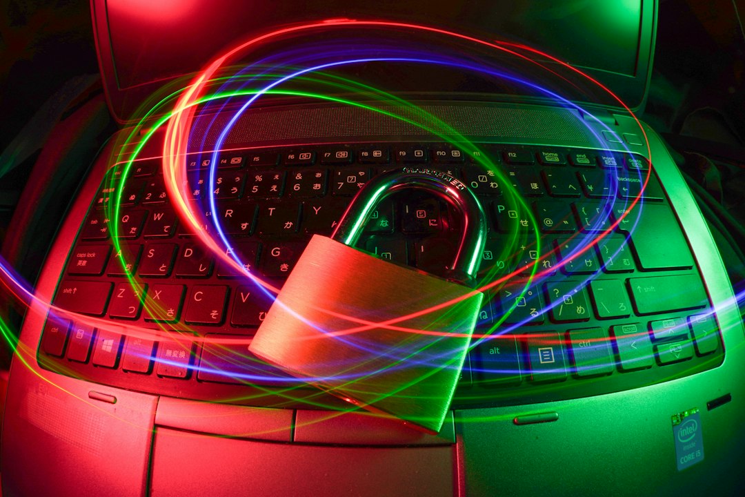 Security concept: a padlock on a laptop keyboard with neon light trails, signaling data protection and cybersecurity.