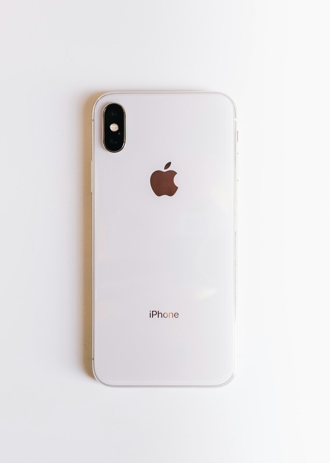 White iPhone back showing dual-camera bump and Apple logo on a white surface