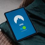 Tablet screen shows a VPN app with a mountain logo and a connected status (green circle) inside a blue interface.