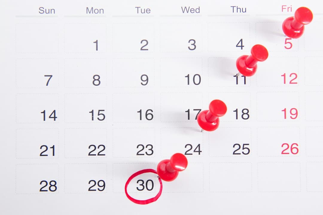 Calendar page with red push pins marking events on the 5th, 11th, 17th, 24th and a red circle around the 30th