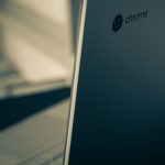 Close-up of a laptop lid showing the Chrome logo on a blue-tinged surface.