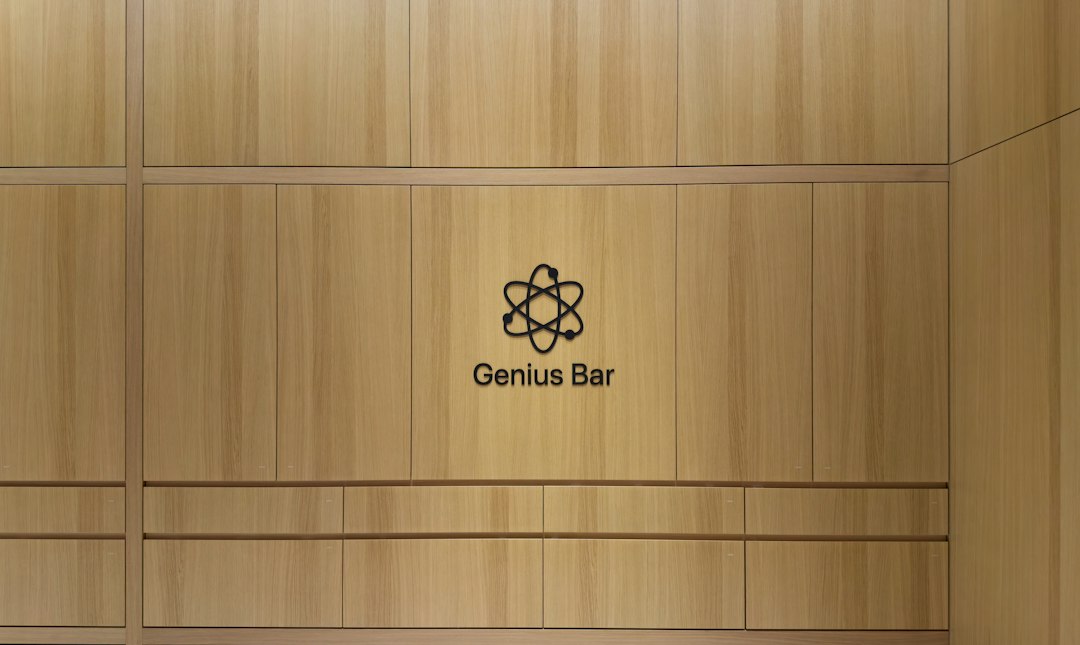 Wooden wall with a black Genius Bar logo and the words 'Genius Bar' in the center.